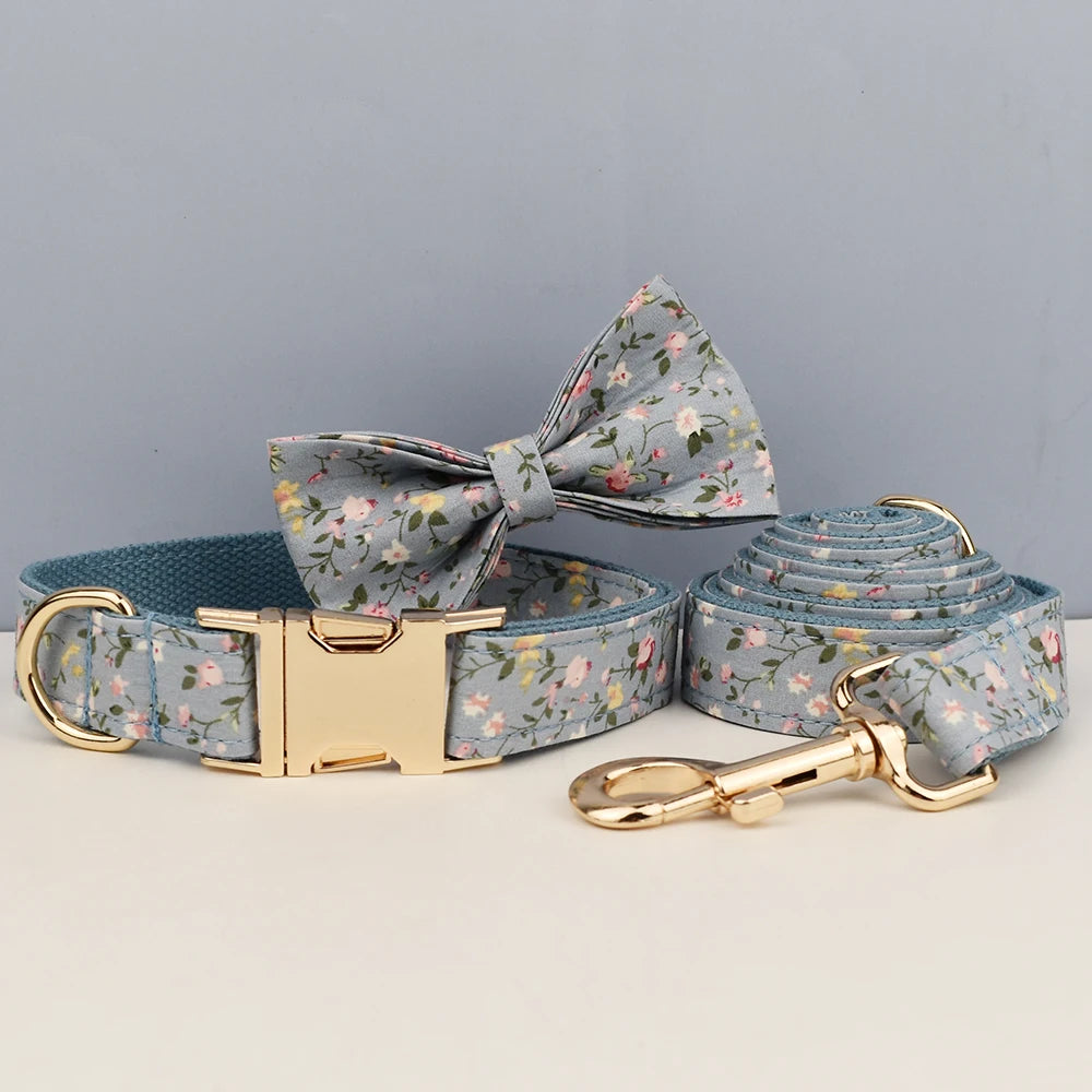 Dog collar, bow tie, and leash set with floral pattern on a gray background