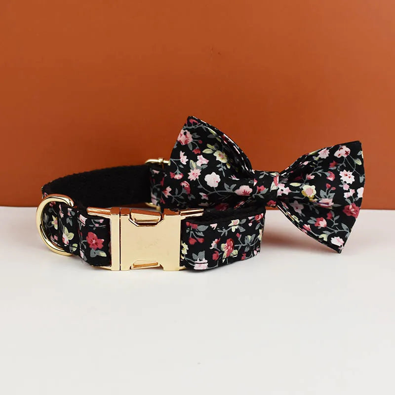 Floral dog collar and bow tie set on a white surface with a brown background