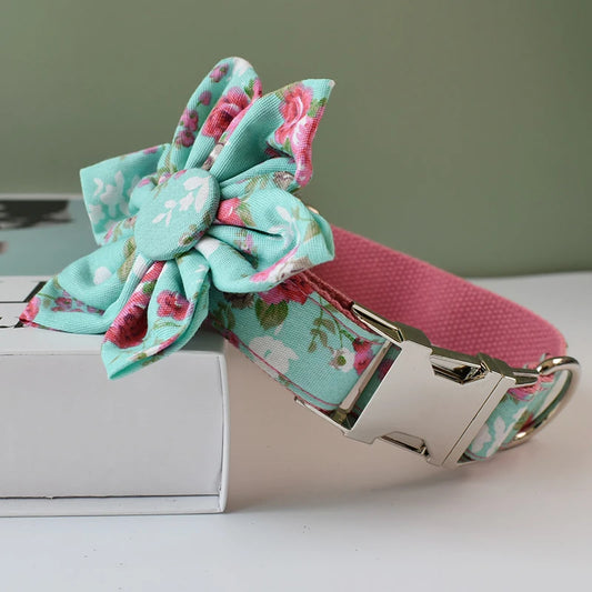 Floral dog collar with a pink internal strap on a white surface