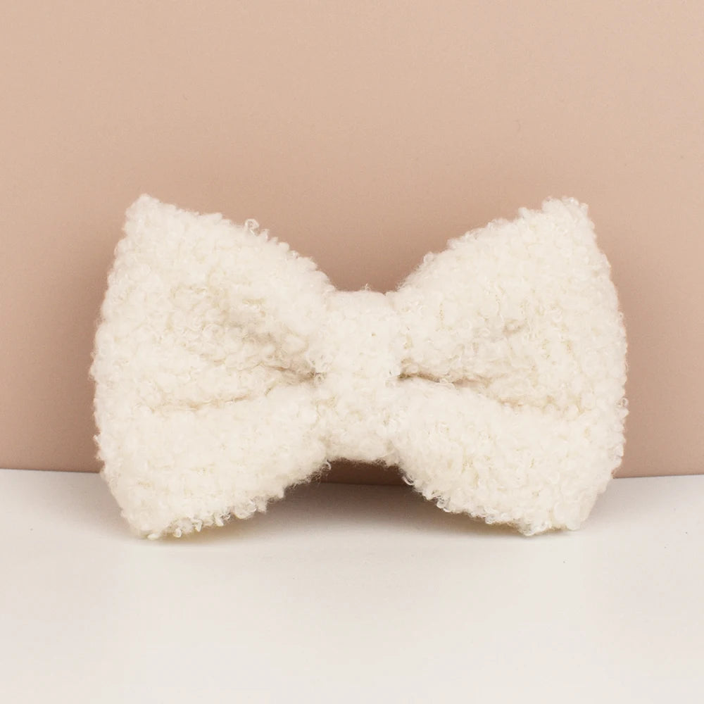 White fluffy bow-shaped pillow on a beige background