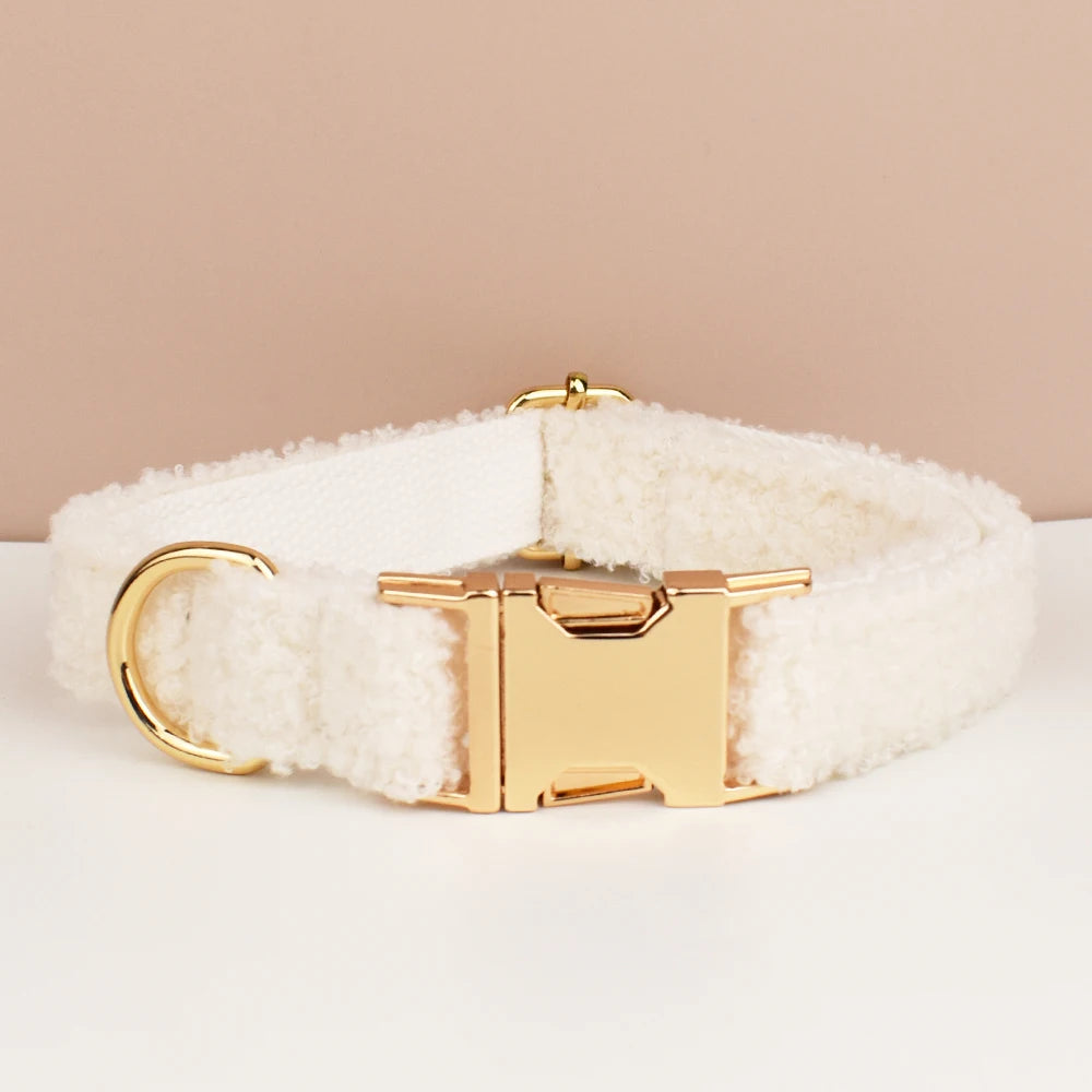 White fluffy dog collar with gold buckle on a beige background