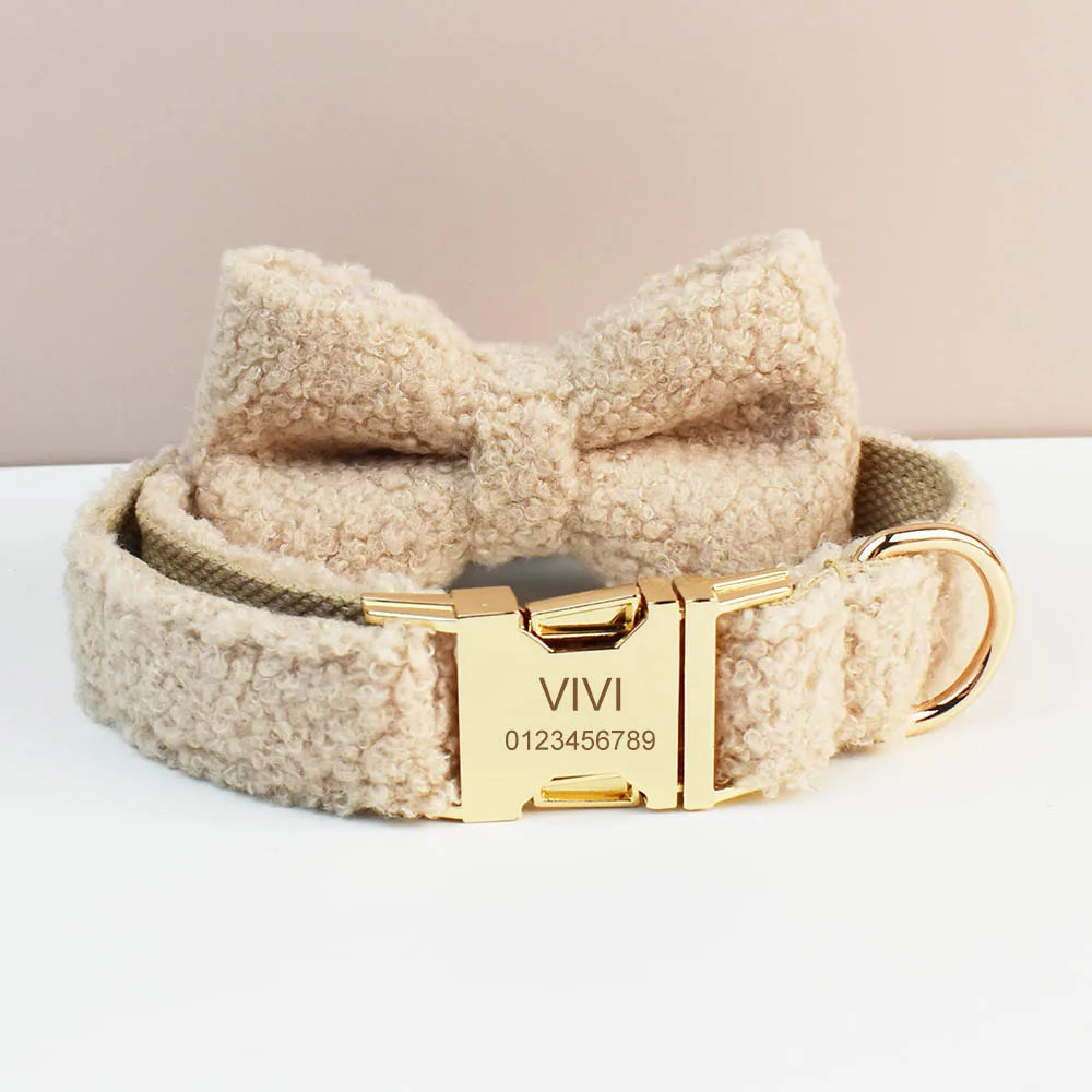 Beige dog collar with bow and gold buckle on a white surface