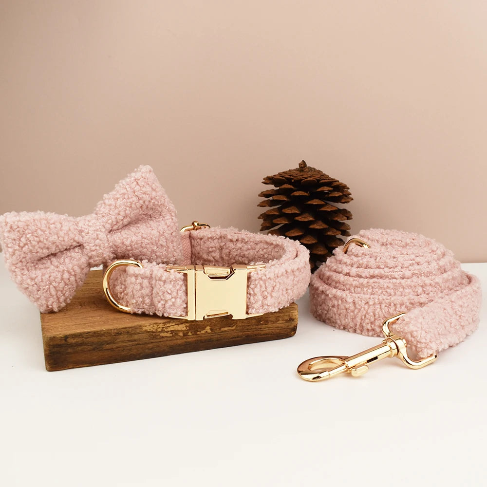 Pink boucle dog collar set with leash and detachable bow tie, designed with gold hardware.