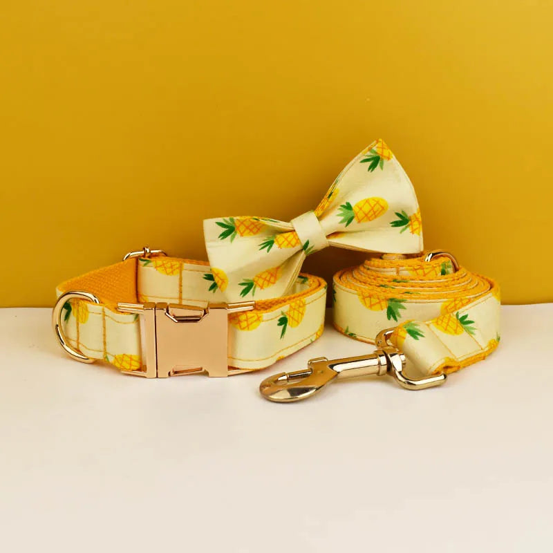 Dog collar, bow tie, and leash set with pineapple pattern on a yellow background