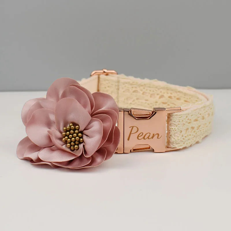 Dog collar with a pink floral accessory and rose gold hardware on a gray background