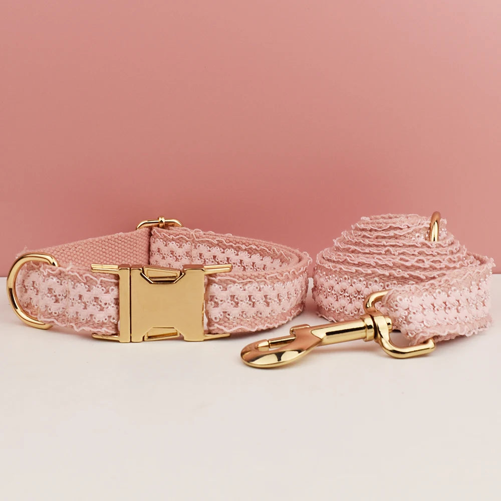 Pink lace dog collar and leash set with gold hardware on a pink background