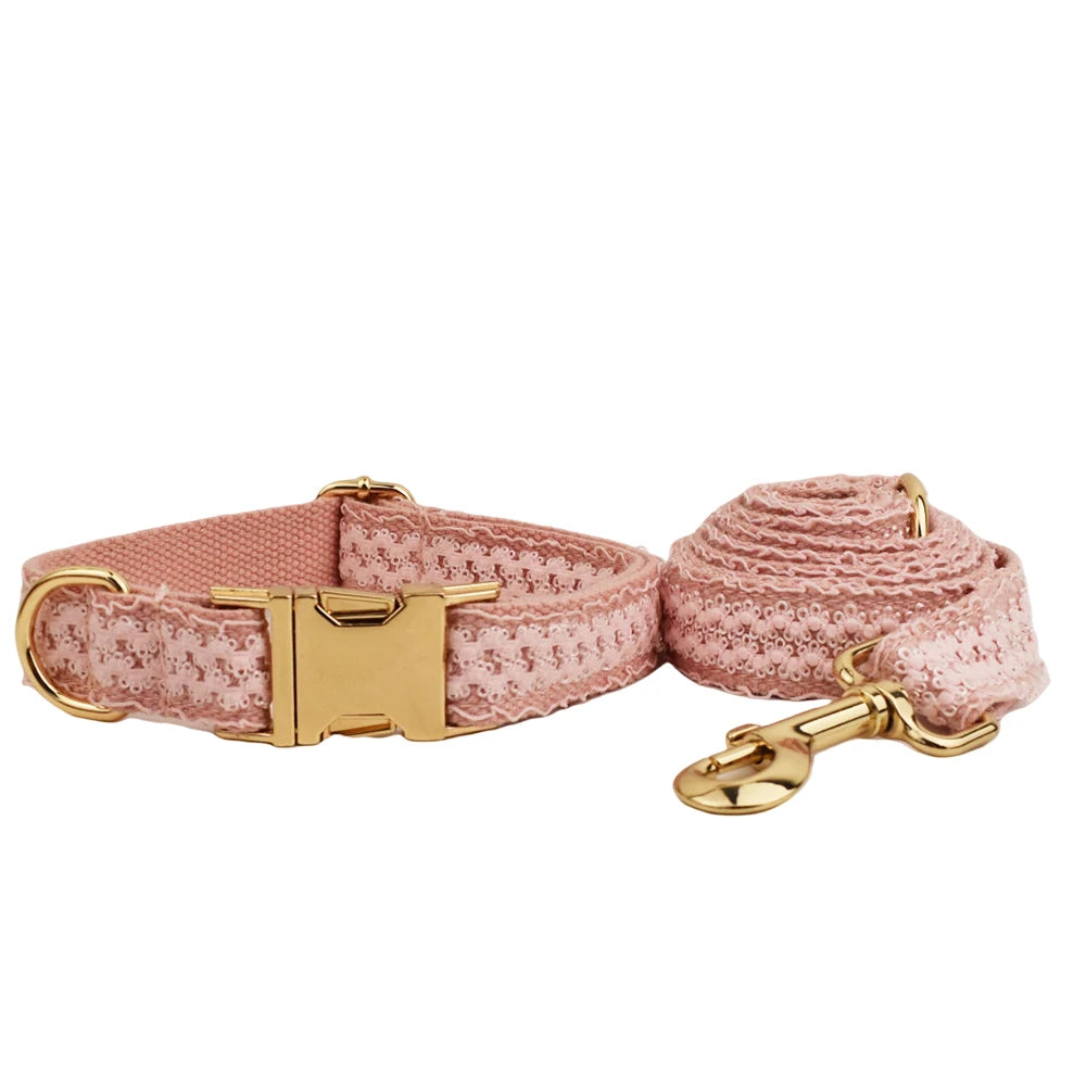 Pink dog collar and leash set with gold hardware on a white background