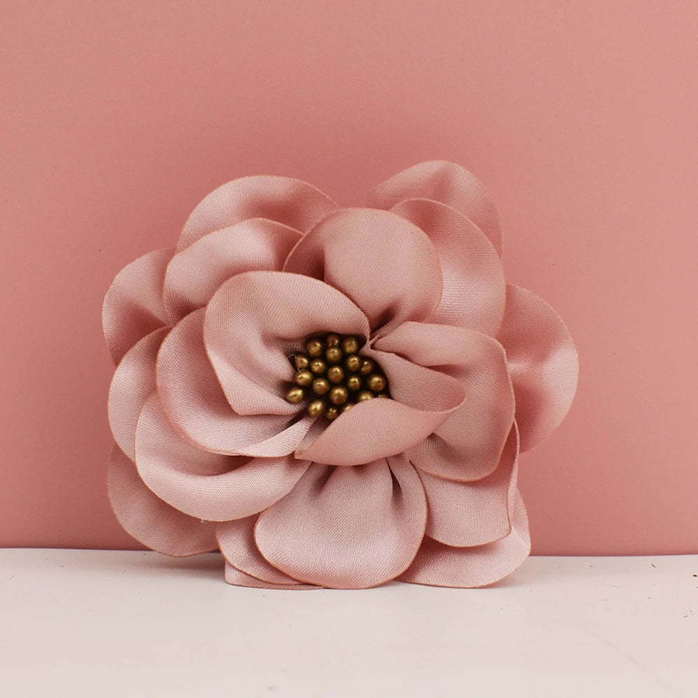 Pink flower-shaped object with a gold center on a pink background
