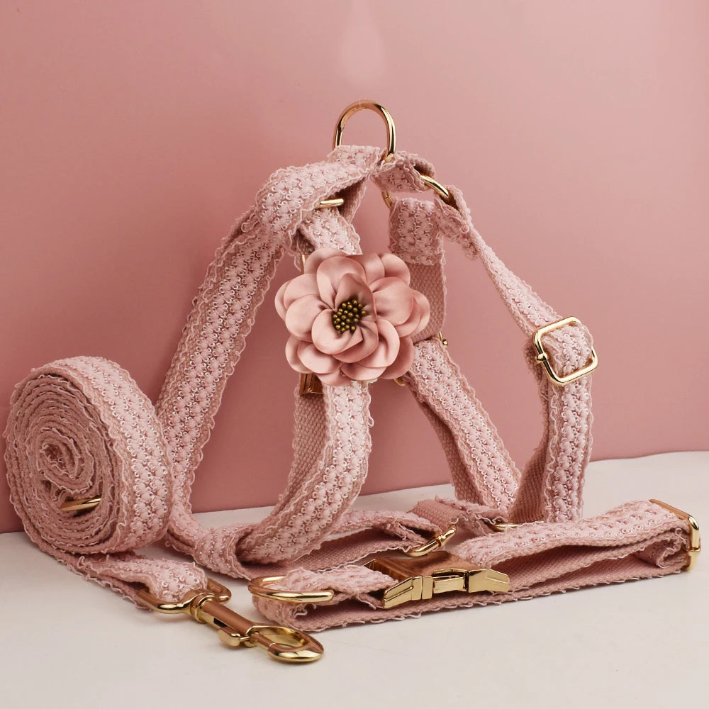 Pink dog harness and leash set with floral design on a pink background