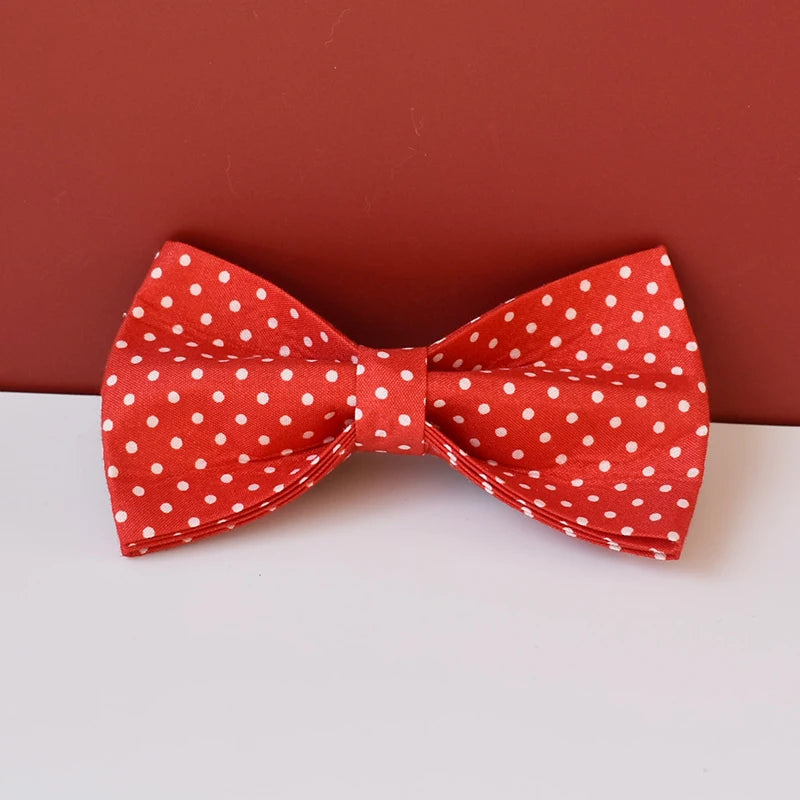 Red dog bow tie with white polka dots on a red background