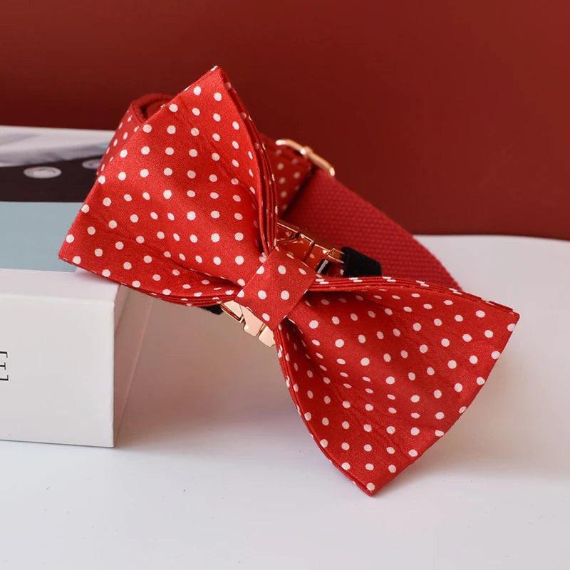 Red polka dot bow tie on a white surface with a blurred background