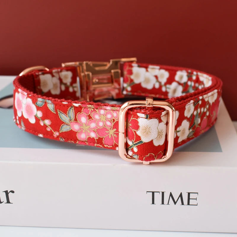 Red floral dog collar with a rose gold buckle on top of a 'TIME' magazine.