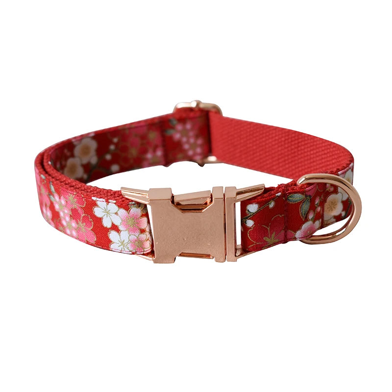Red floral dog collar with a rose gold buckle on a white background