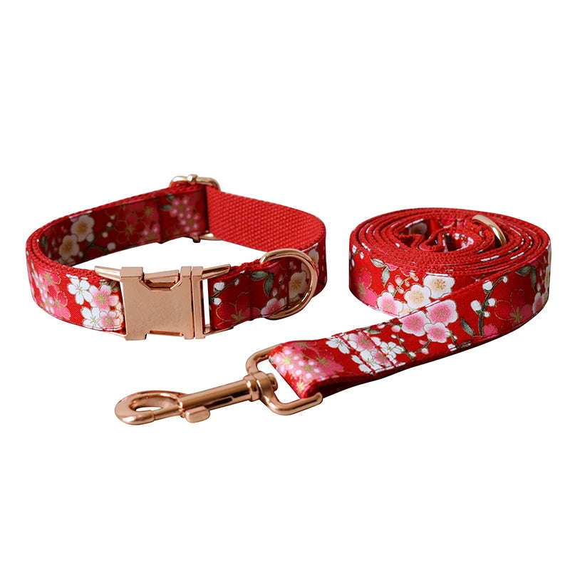Red floral dog collar and leash set on a white background