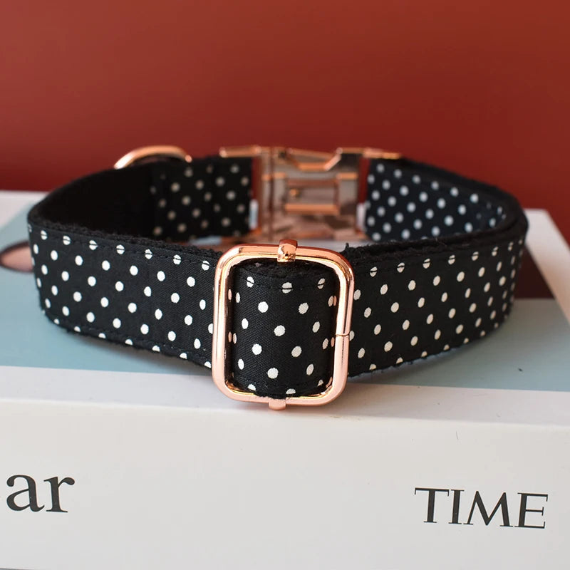 Black polka dot dog collar with rose gold buckle on a magazine