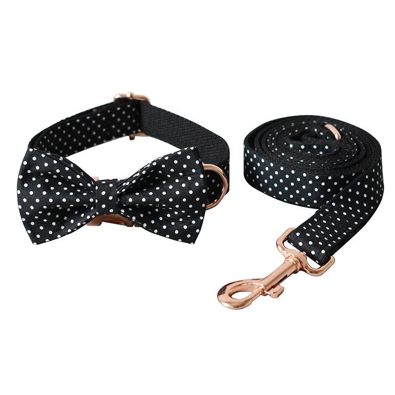 Black polka dot dog collar and leash set with rose gold hardware on a white background