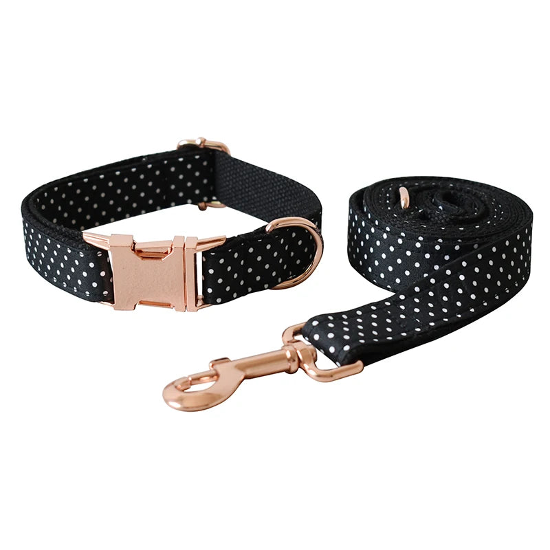 Black polka dot dog collar and leash with rose gold hardware on a white background