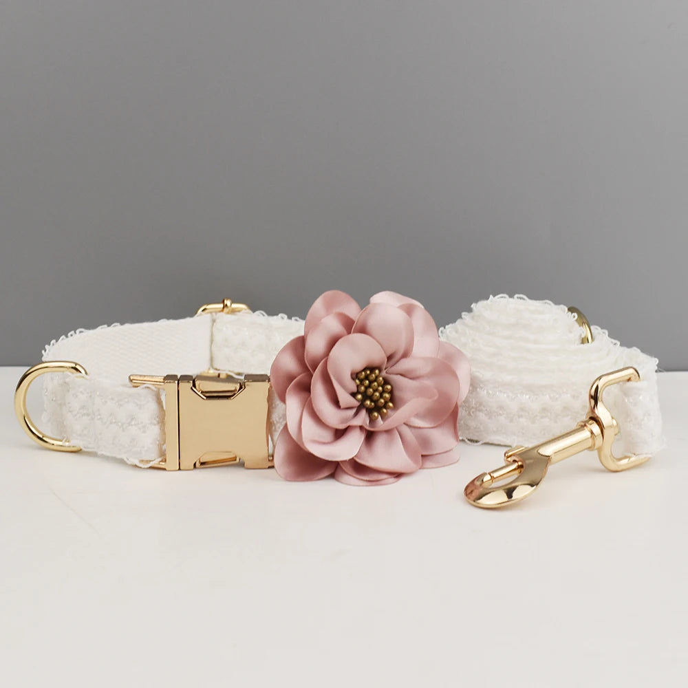 White textured dog collar with a pink floral accessory on a gray background