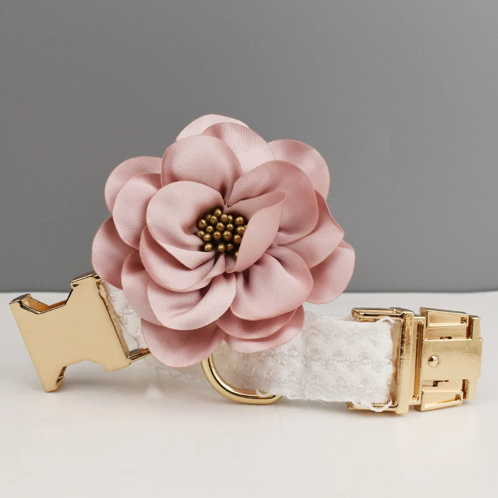 Dog collar with a pink flower accessory on a gray background