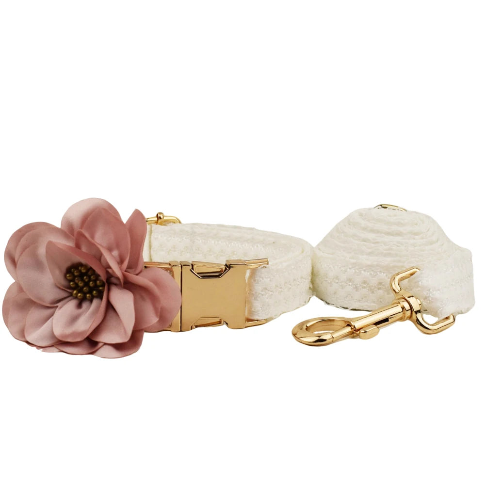Dog collar with pink flower and beige ball on a white background