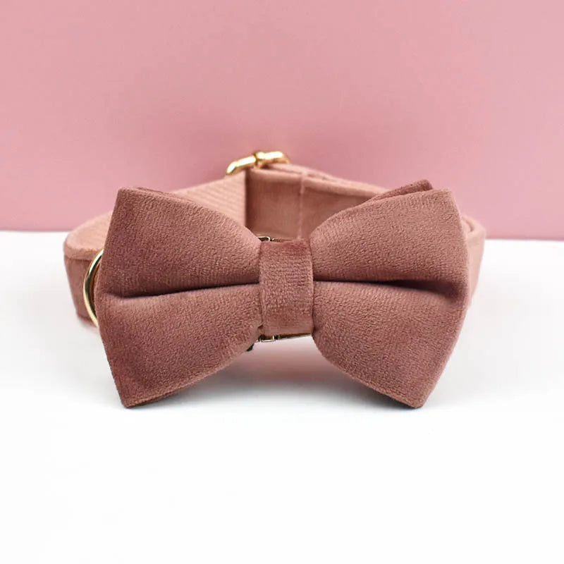 Pink bow tie on a white surface with a pink background