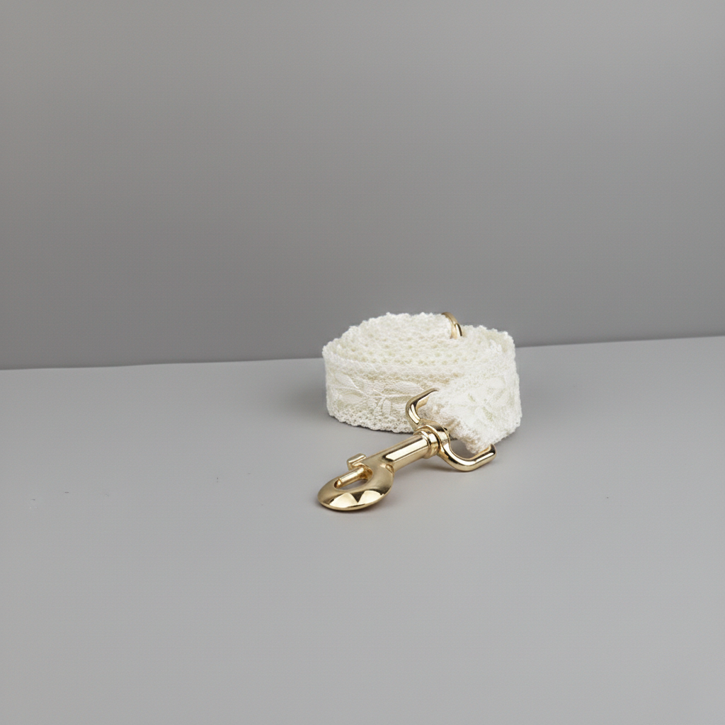 White textured dog leash with a gold clasp on a gray background