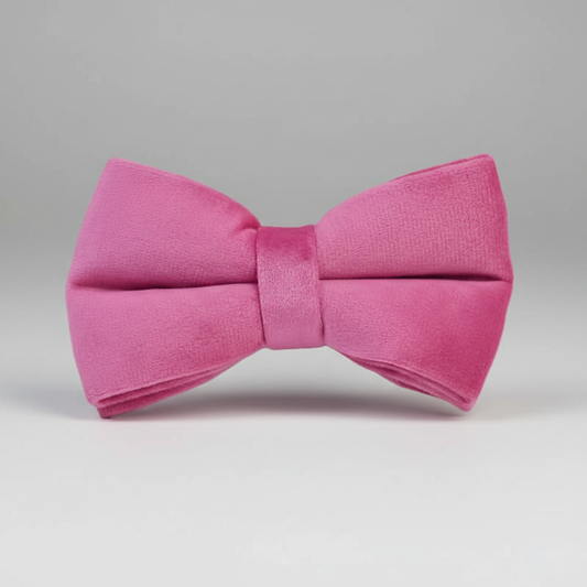 Pink bow tie on a gray background