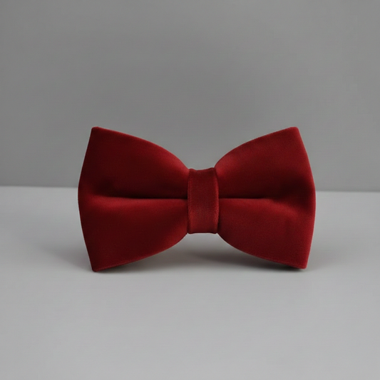 Red bow tie on a gray background