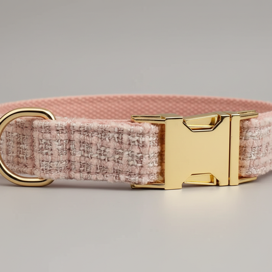 Pink textured dog collar with a gold buckle on a light gray background