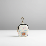 Small waste bag holder with heart pattern on a gray background