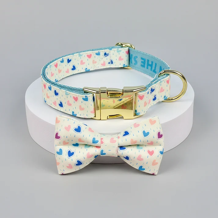Dog collar and bow tie set with heart pattern on a gray background
