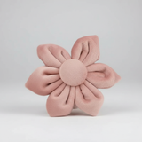 Pink flower-shaped cushion on a light gray background