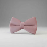 Pink bow tie on a gray background