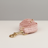 Pink textured keychain with gold clasp on a white surface
