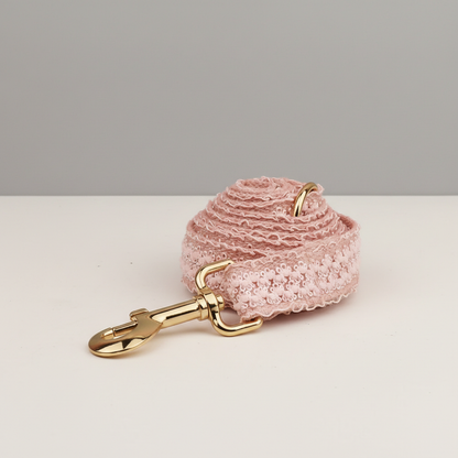 Pink textured keychain with gold clasp on a white surface
