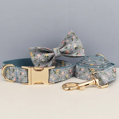Dog collar, bow tie, and leash set with floral pattern on a gray background