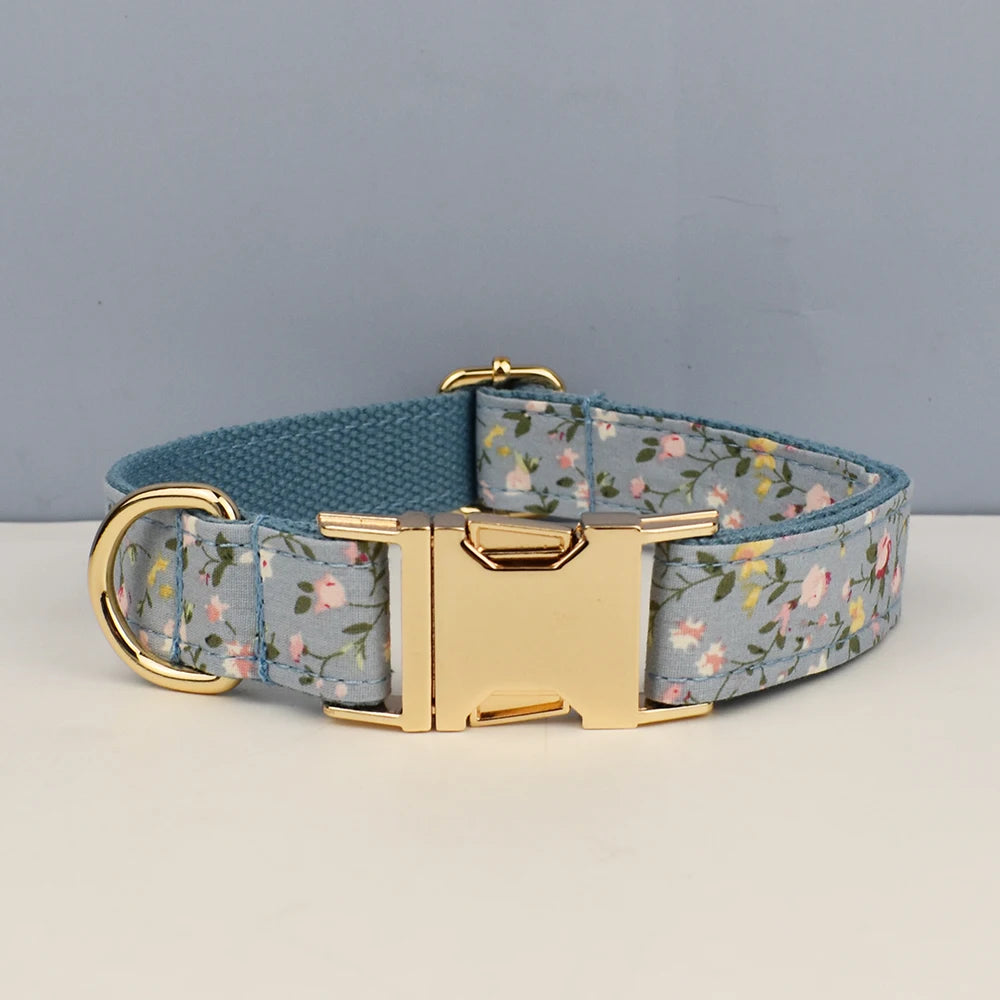Dog collar with floral pattern and gold buckle on a gray background