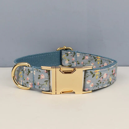 Dog collar with floral pattern and gold buckle on a gray background