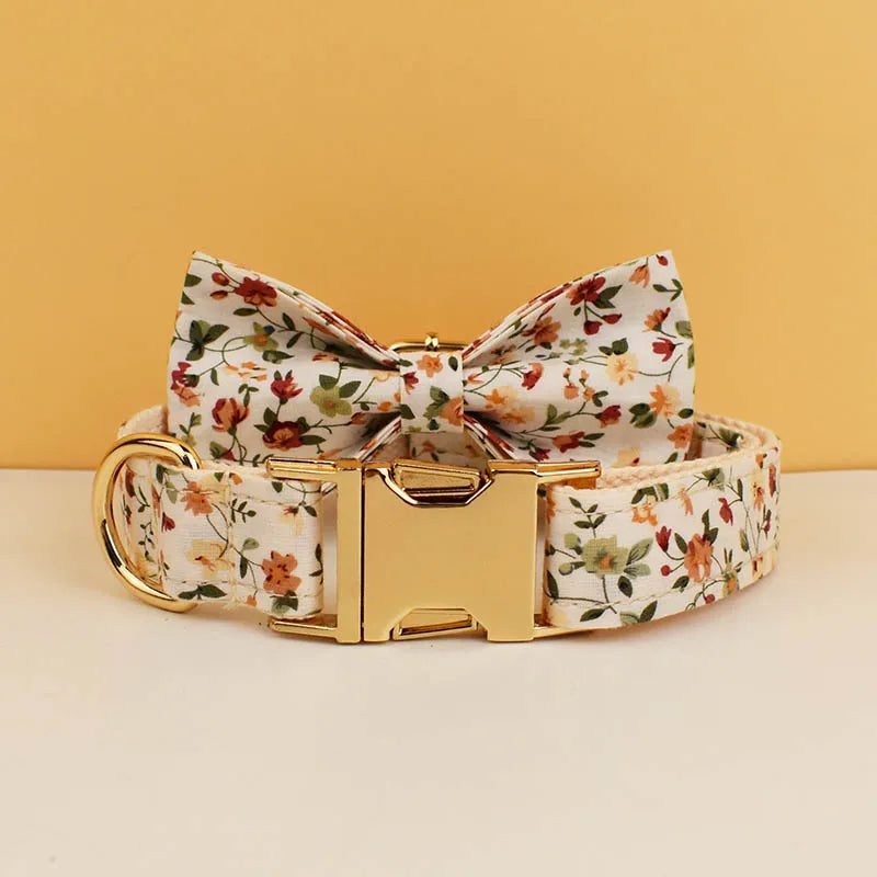 Floral-patterned dog collar with gold buckle on a beige background