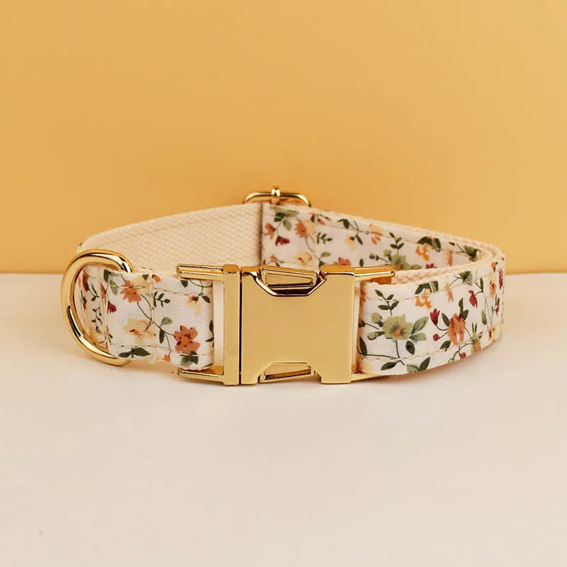 Floral-patterned dog collar with a gold buckle on a beige background