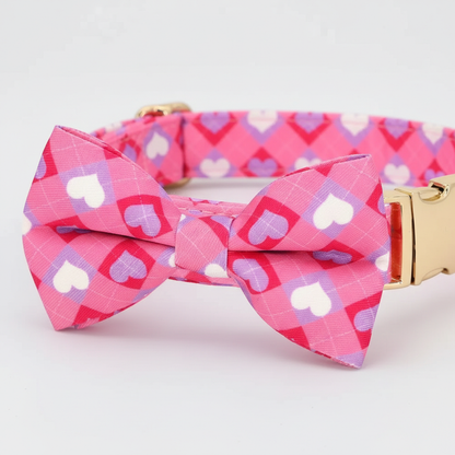 Pink heart-patterned bow tie and collar set on a light gray background