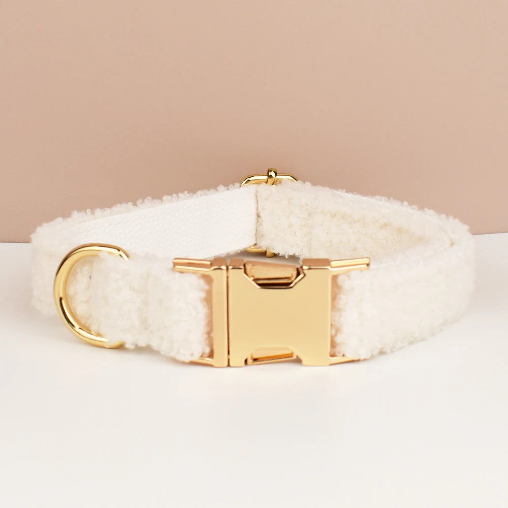 White sherpa dog collar with gold hardware on a beige background