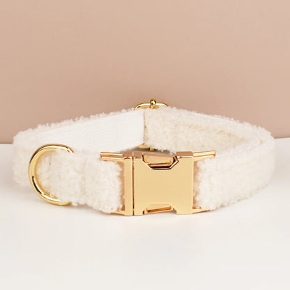 White fluffy dog collar with gold buckle on a beige background