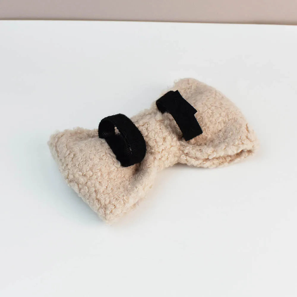 Pair of beige fleece dog toys with black Velcro straps on a white background
