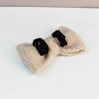 Pair of beige fleece dog toys with black Velcro straps on a white background