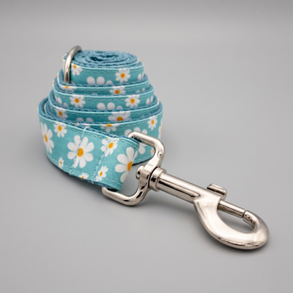 Dog leash with floral pattern and metal clip on a gray background