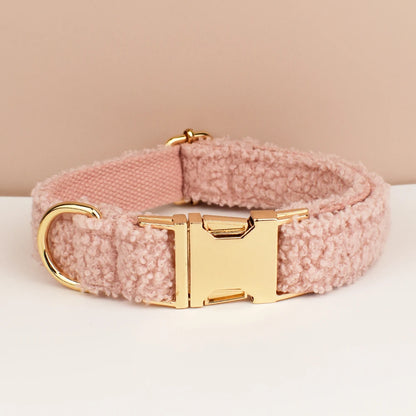 Pink dog collar with gold buckle on a beige background