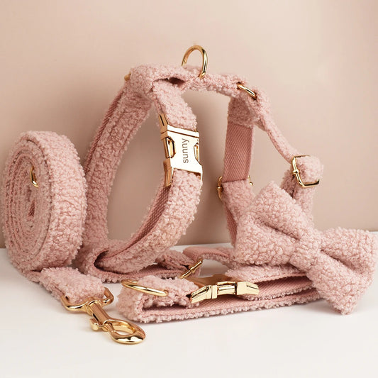 Pink dog harness set with matching leash, collar, and bow tie, featuring soft boucle fabric.