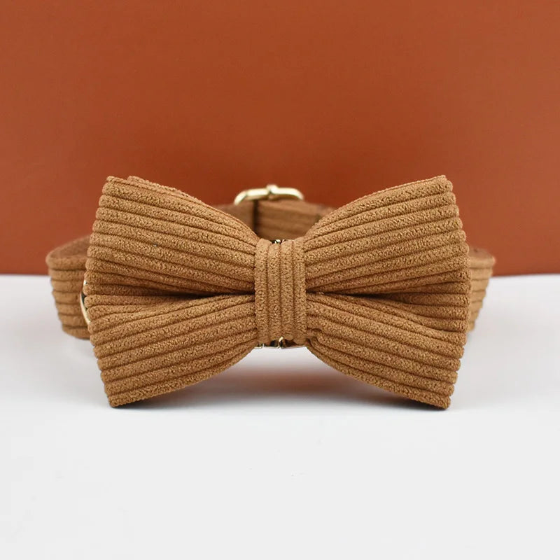 Brown bow tie on a white surface with a brown background