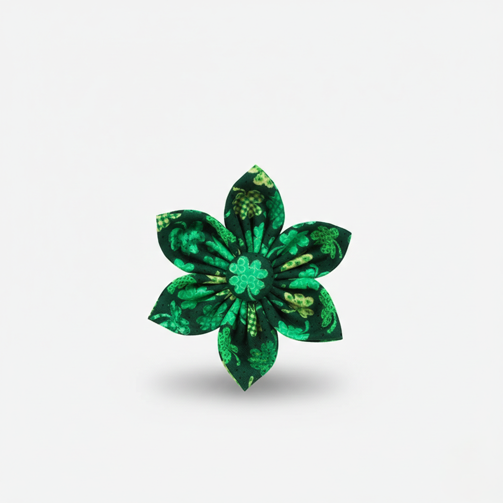 Green floral brooch on a light gray background